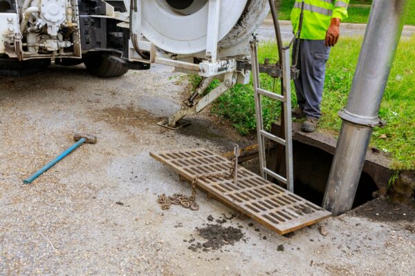 Sewage industrial cleaning truck clean blockage in a sewer line.